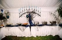 Buffet table with chafing dishes under draping inside a marquee