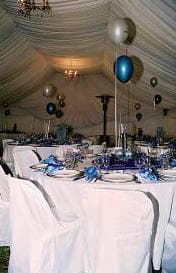 Inside a marquee dressed with balloons and set tables for a function